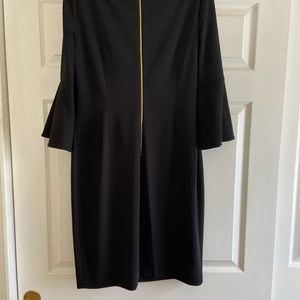 Women’s Calvin Klein Black Dress. This classic fit dress feature’s bell sleeves.